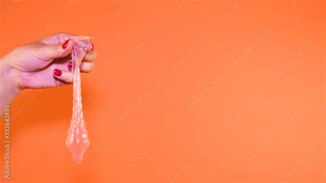 Woman Holding Condom Prevent Pregnancy Is Her Hand Holding An Open Condom The Concept Of Safe