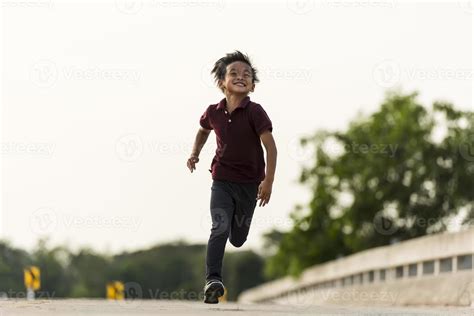 A Little Boy Runs Along The Bridge 13346218 Stock Photo At Vecteezy