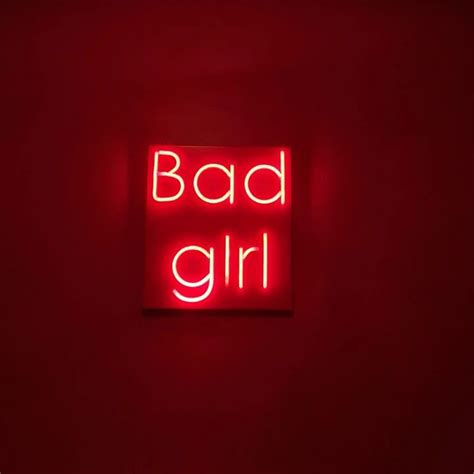 A Red Neon Sign That Says Bad Girl
