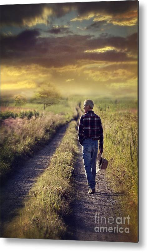 Man Walking Down A Country Road At Sunset Metal Print By Sandra Cunningham