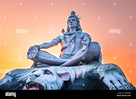 Hindu God Lord Shiva Statue In Meditation Posture With Dramatic Sky At