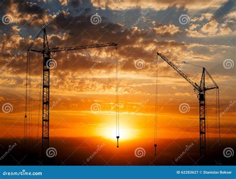 Cranes Working At Building Construction Site Sunset Sky Silhouette Industrial Background Royalty