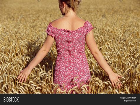 Woman Facing Away From Camera In Wheat Field Stock Photo And Stock Images