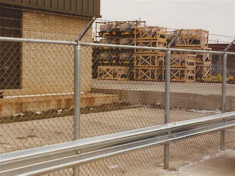 Commercial Chain Link Fence Enclosure With Barbed Wire And Guard Rail