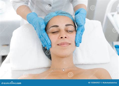 Beautician Makes Professional Massage Of The Patient`s Face A Young Girl Is Undergoing A Course
