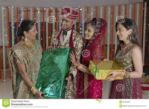 In hindu weddings, gifting forms an integral part of the ceremony. Bride And Groom Receiving Gifts From Relatives. Stock ...