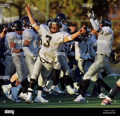 Columbine High School quarterback Garrett Looney (3) raises his arms in