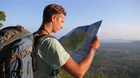 Traveller Man With Map And Backpack Exploring Country On Trekking