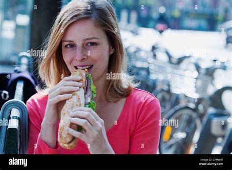 Woman Eating A Sandwich Stock Photo Alamy