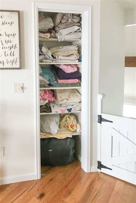 An Open Closet With Clothes On The Shelves