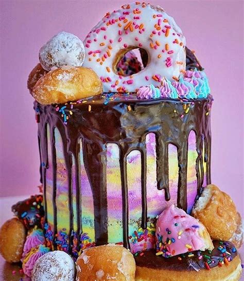 There Is A Large Cake With Donuts On It And Sprinkles All Around