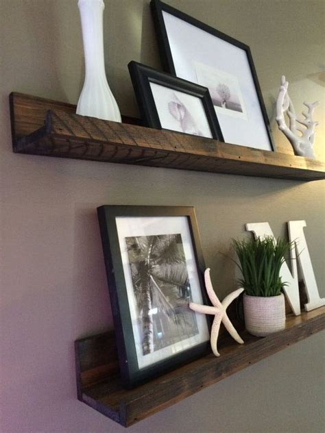 Floating shelves with picture frames. Hanging in my living room - love the rustic look! Shelf ...