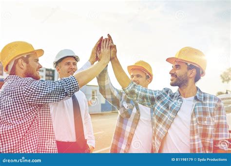 Close Up Of Builders In Hardhats Making High Five Stock Image Image
