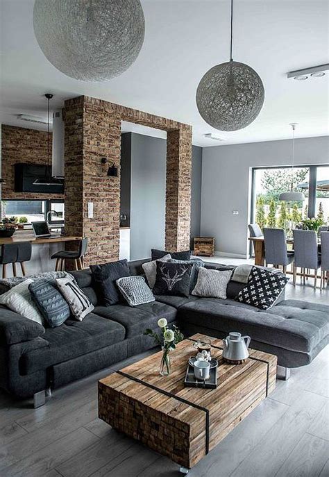Open Spaced Grey Living Room With Brick Walls And Raw Wooden Table