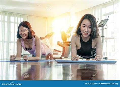 Attractive Cheerful Asian Woman Wearing Sportswear With Push Up Arm