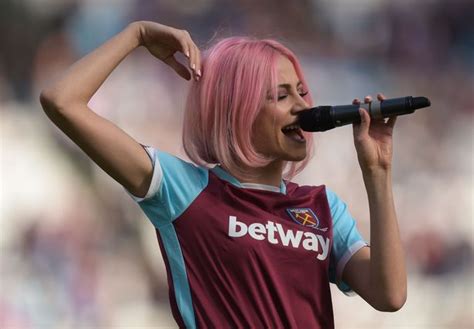 cheeky pixie lott shows off her bum in denim shorts during west ham united half time performance