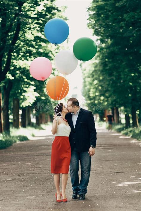 Fun Romantic Couple Kissing Outdoors Beautiful Woman Holding Balloons