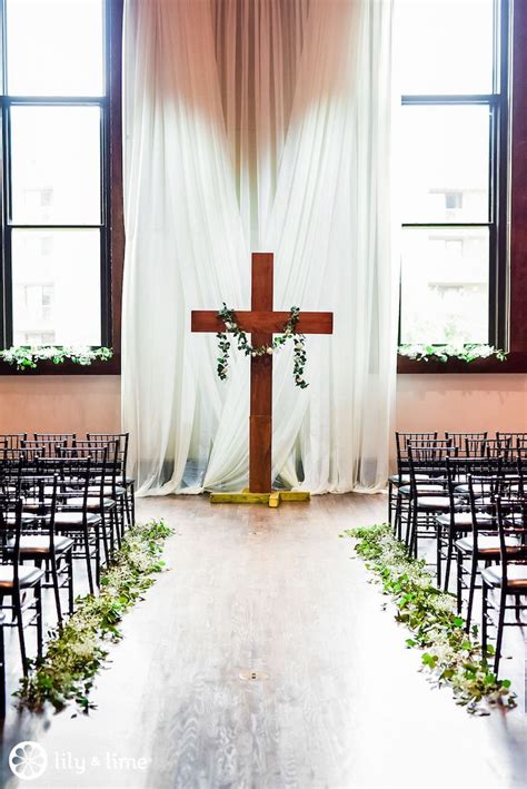 An Empty Church With Chairs And A Cross On The Wall In Front Of A Window