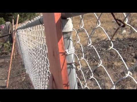 Fasten the top ends with 2 in (5.1 cm) bolts. Chain link fence with wooden posts. | Chain link fence ...