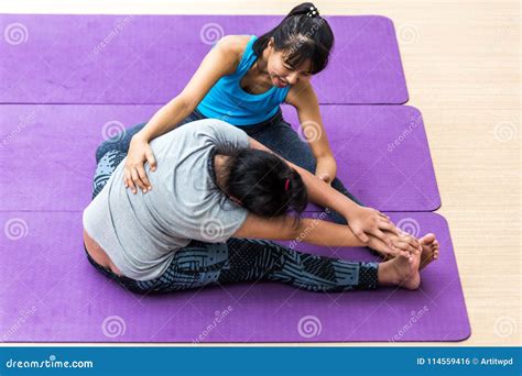 Girl Trained Yoga Stretch Closely By Yoga Teacher At Yoga Studio In