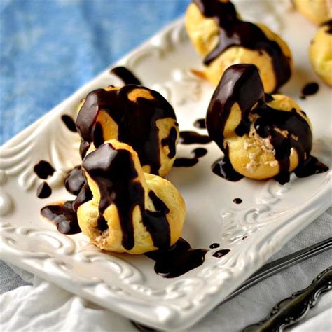 Tender cupcakes filled with fluffy pastry cream and topped with rich chocolate ganache. Cream puffs with espresso cream filling
