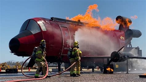 Fire Crews Participate In Aircraft Rescue Fire Fighter Training At