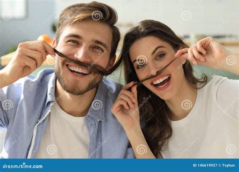 Portrait Of Cute Young Playful Couple Teasing With Fake Mustache