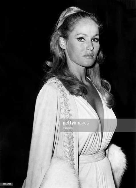 Swiss Born Actor Ursula Andress Stands At An Event Wearing A Low Cut