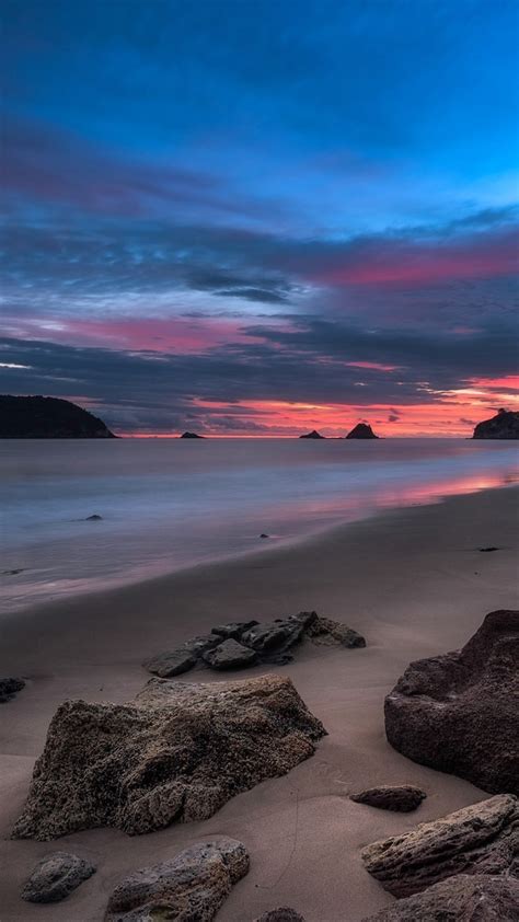 Download 1080x1920 Ocean Beach Rocks Horizon Sunset