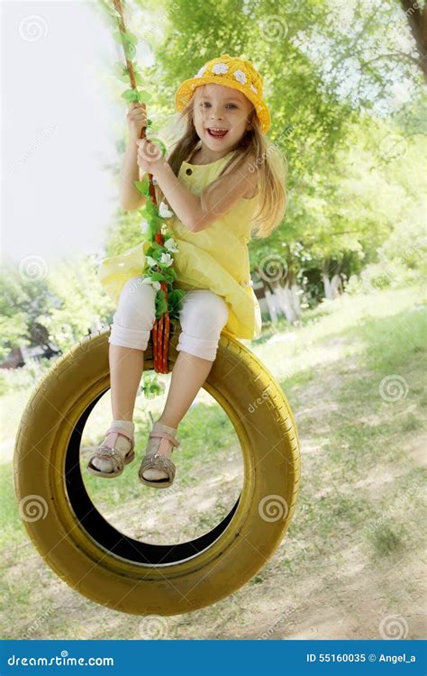 Girl In Yellow Dress On Tire Swing Stock Image Image Of Park Hanging