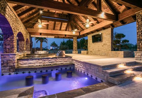 An Outdoor Hot Tub With Lights On The Ceiling And Steps Leading Up To