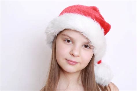 Beautiful Teen Girl In Santa Claus Hat Sitting And Dreaming Of A T Expresses Happiness And