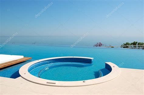 Infinity Swimming Pool With Jacuzzi By Beach At The Modern Luxur