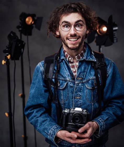 Young Photographer Holds A Camera Studio Portrait With Lighting