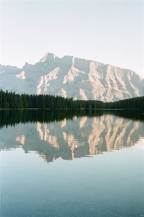 Reflection Of Mountain In Still Lake By Stocksy Contributor Justin