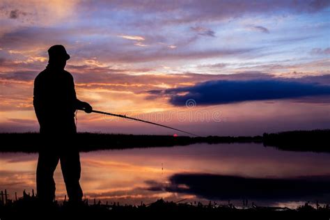 Fisher Man Fishing On A Lake Bank At Sunset Stock Photo Image Of