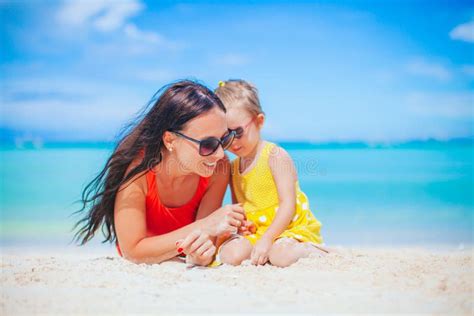 Beautiful Mother And Daughter At The Beach Enjoying Summer Vacation