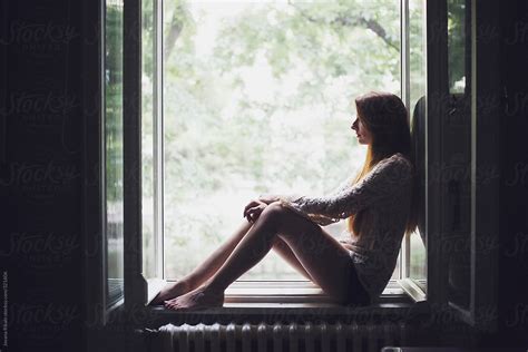 Woman Sitting At Window Sill By Stocksy Contributor Jovana Rikalo