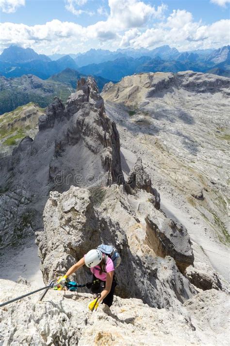 Attractive Brunette Female Climber On A Steep Via Ferrata In The