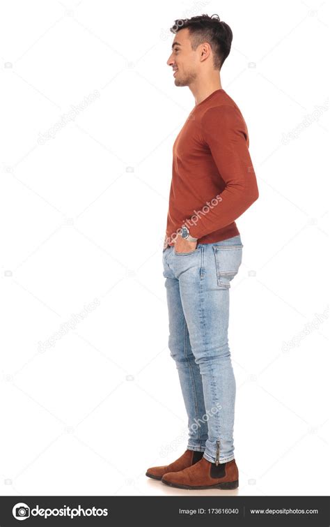 Side View Of Smiling Man Standing With Hands In Pockets ⬇ Stock Photo