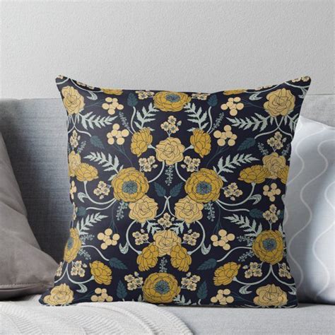 A Black And Yellow Floral Pillow On A Couch