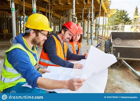 Craftsmen Team And Architect On The Construction Site Stock Photo