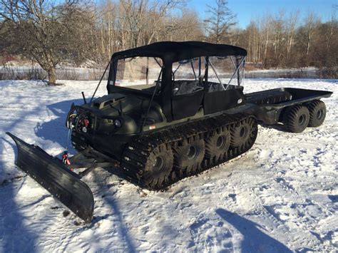 Winch, front bumper, side grab rails, and rear bench seats. Argo Avenger 8x8 with soft top, tracks, plow, trailer, and ...