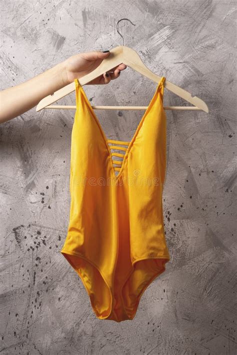 Bright Yellow Swimsuit On A Hanger Summer Wardrobe Concept Stock