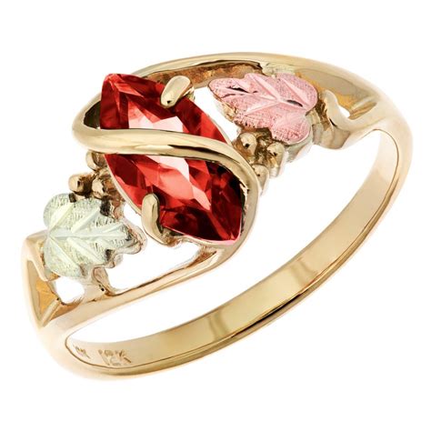 Black hills opal ring showcasing a beautiful 7 x 5 mm oval shaped opal stone adorned with 12k gold rose flower. 10K Black Hills Gold Ladies Ring with Garnet - BlackHillsGold.Direct - Klugex
