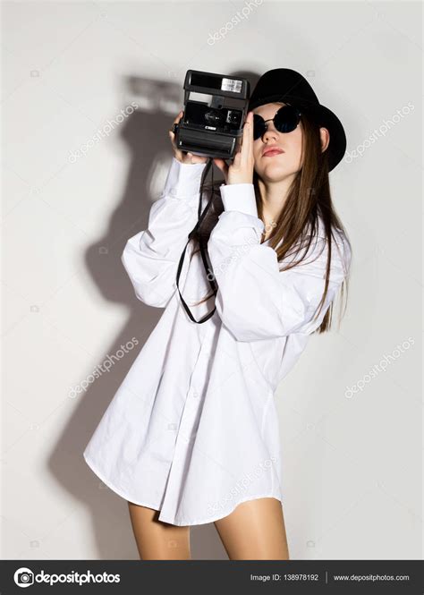 Naked Girl In A Mans White Shirt Sunglasses And Black Hat Holding Camera Stock Photo Sandy
