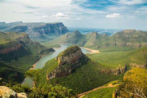 A High View Of A Lush Mountain Valley With A Lake In South Africa Rpics