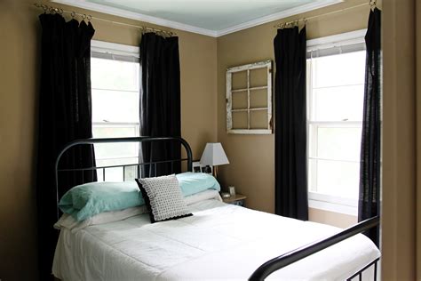Small Guest Room With Full Size Black Vintage Iron Bed Tan Walls Aqua
