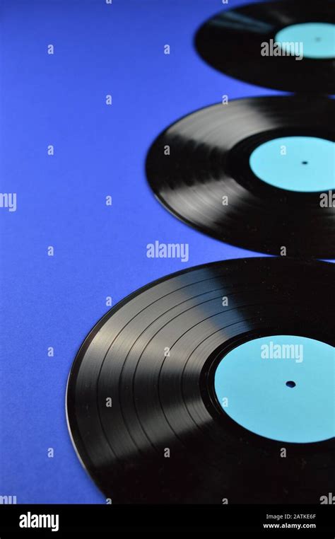 Border Of Old Black Vinyl Records With Blank Cyan Labels On Blue