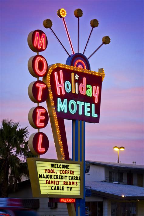 The Motel Sign Is Lit Up At Night